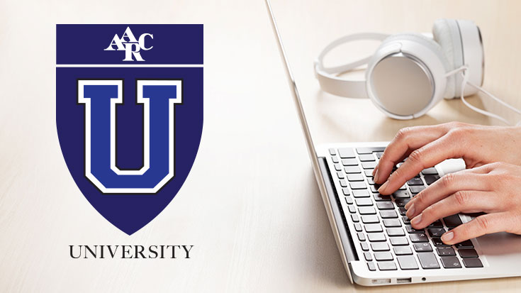 image of woman working on laptop with AARC University logo displayed